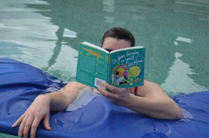 boy reading do your laundry or you'll die alone in pool