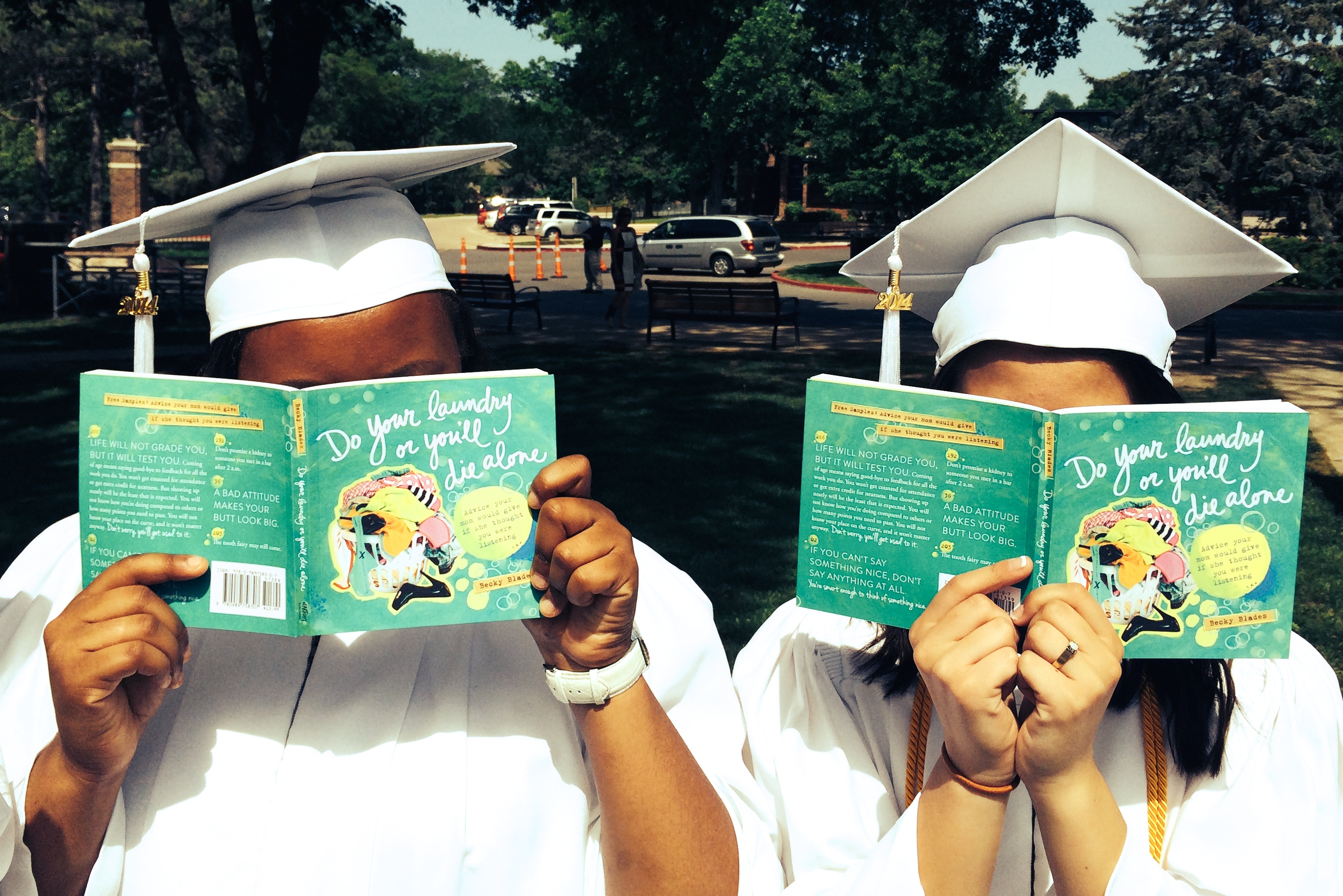 graduates in robes reading do your laundry or you'll die alone book